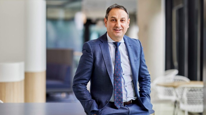 Murat Dizdar PSM, Secretary of the NSW Department of Education in a blue suit.