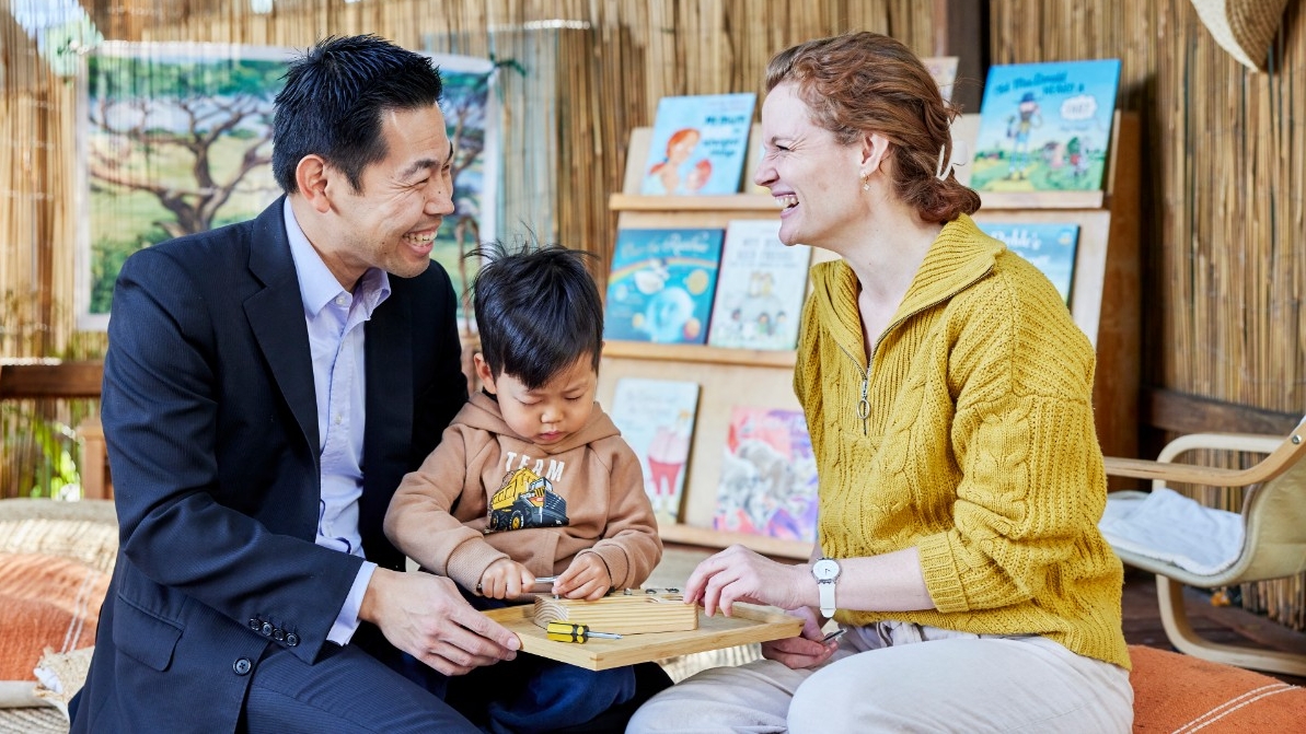 Two educators playing with a child