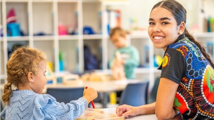 Educator sitting at desk with student