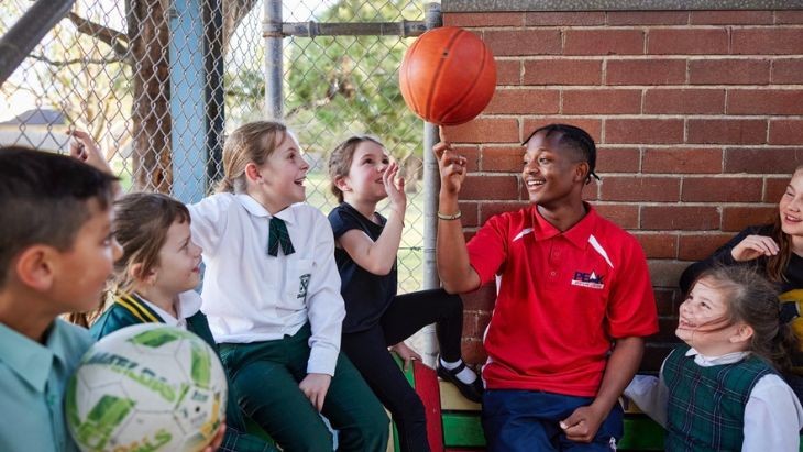Male educator spinning basketball.