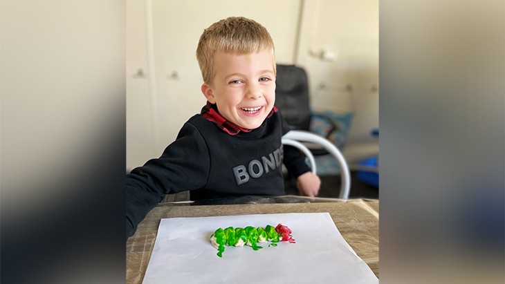 A child smiling at the camera.