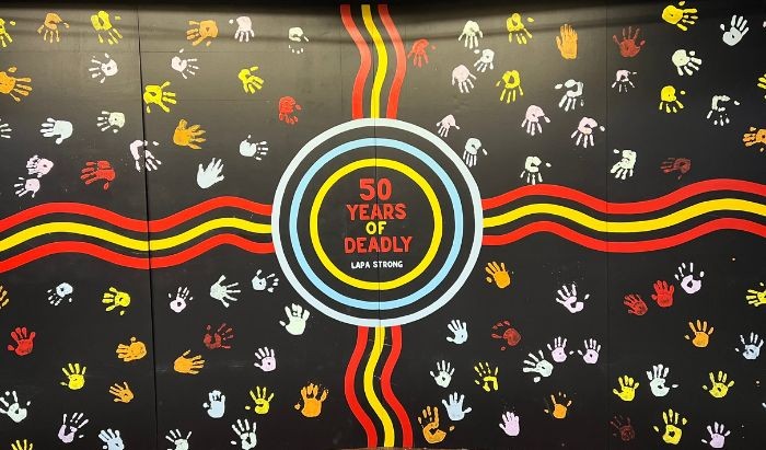 A mural featuring Aboriginal motifs and 50 Years of Deadly in text