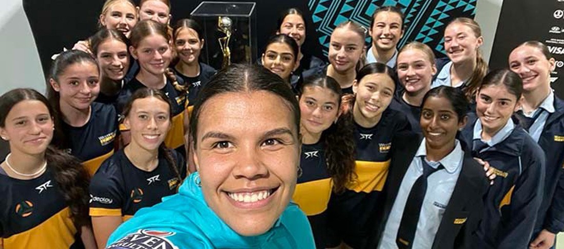 Jada Whyman in a selfie style photo with students 