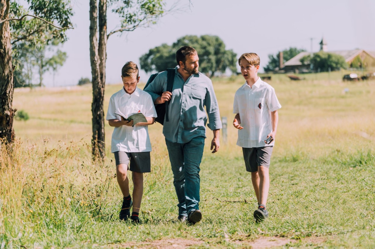 father walking with two high school sons
