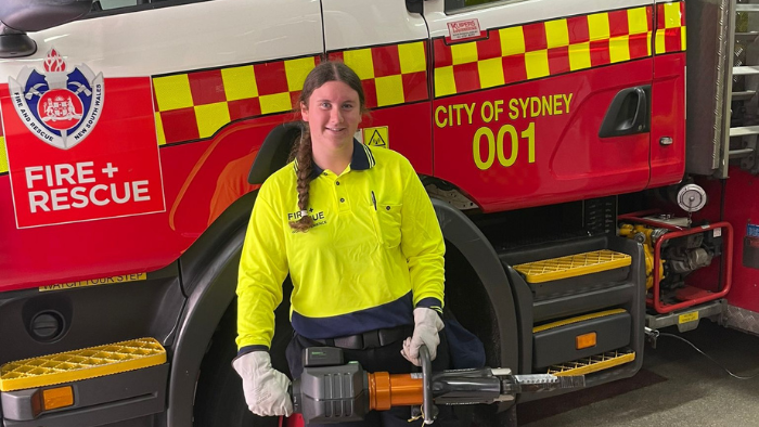 Makayla Allen in front of a Fire and Rescue vehicle