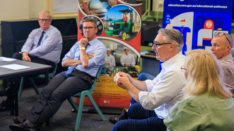 4 male and 1 female NSW High School Principals sit in a group in a discussion of the Educational Pathways Program. Male speaker