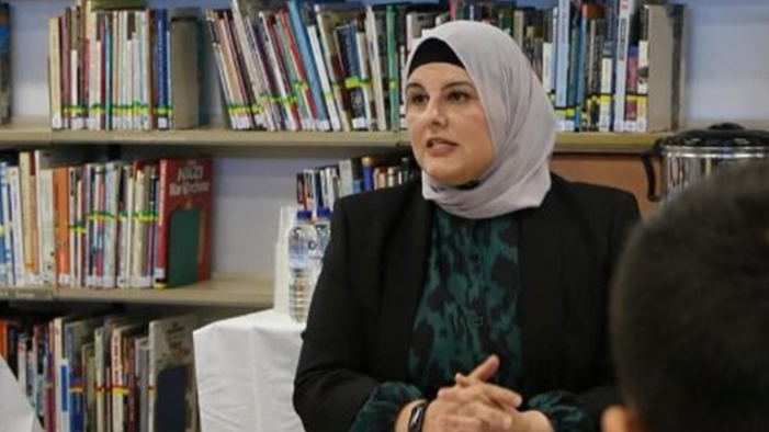 Joumana Youssef addressing students from Granville South Creative and Performing Arts High School
