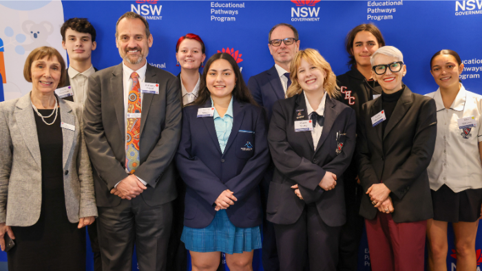 Group of EPP leaders standing with Anthony Angel and students smiling