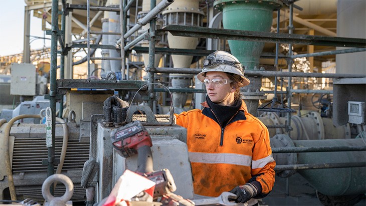Young female apprentice wearing full PPE on work site.