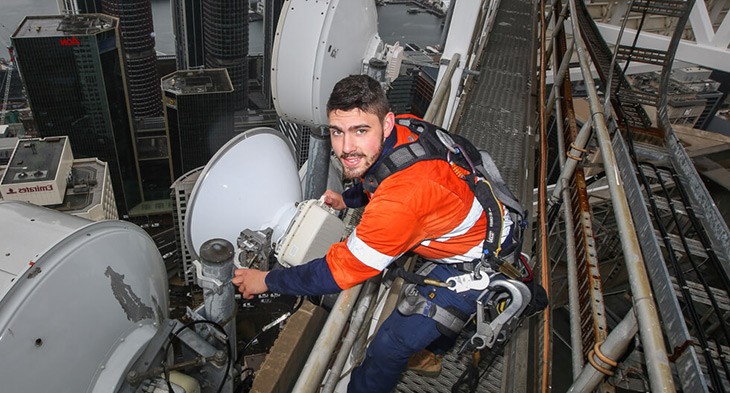 Telecommunications apprentice on building site.