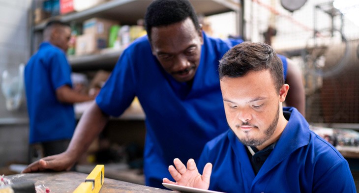 Two men looking at computer screen.