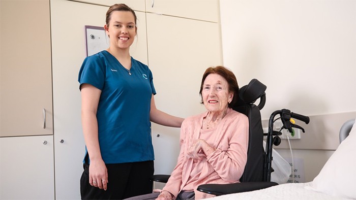 Female aged care trainee with elderly woman.