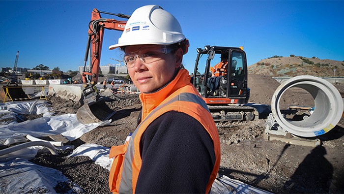 Female apprentice construction worker on site.