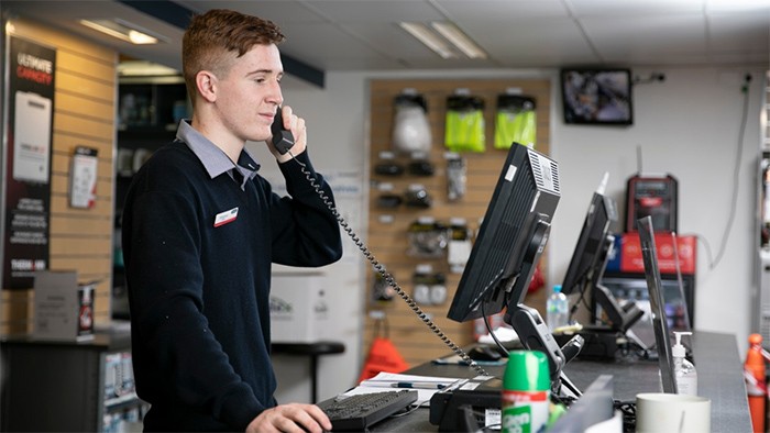VET apprentice on the phone at work