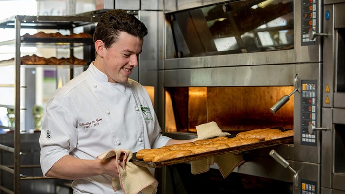 Male apprentice making pastries in bakery