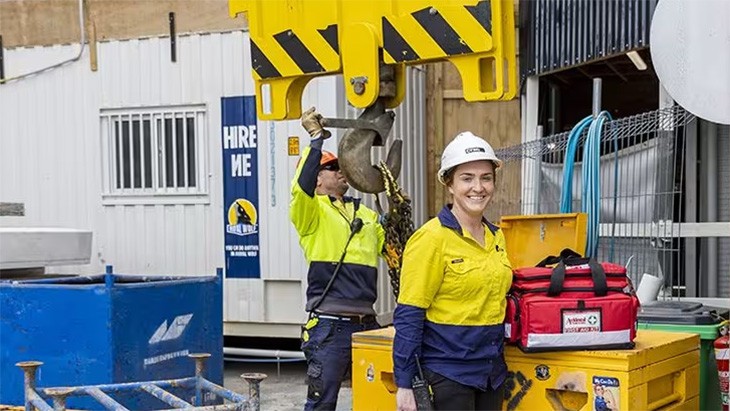 Woman in safety gear smiling at camera.