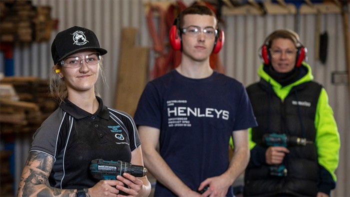 Carpentry apprentices with trainer in workshop