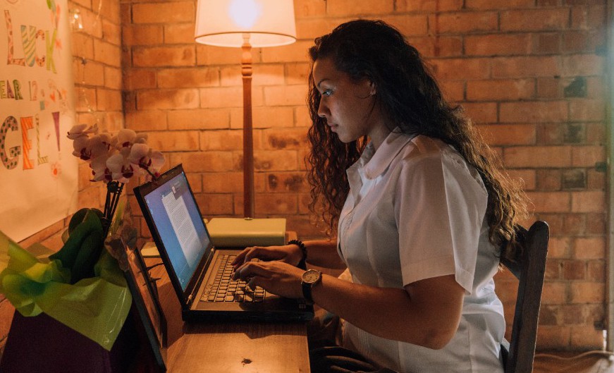 Female student looking at laptop.