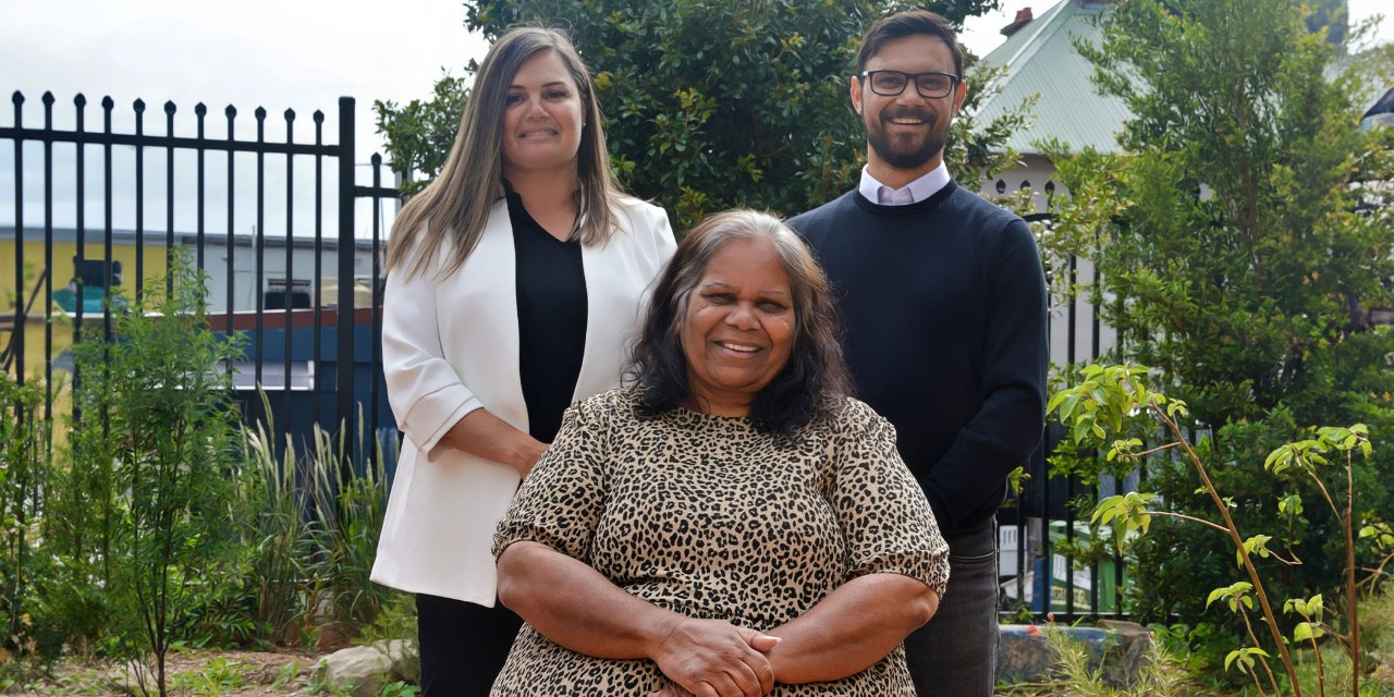 Three educators smiling directly at the camera