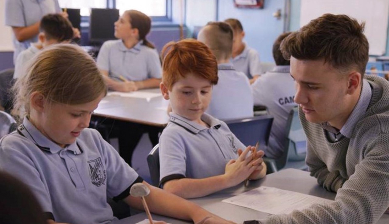 Male teacher smiling at camera