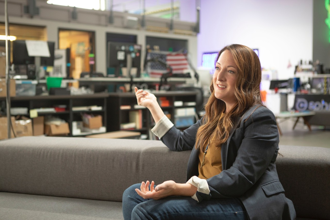 woman sitting and talking using hand gestures