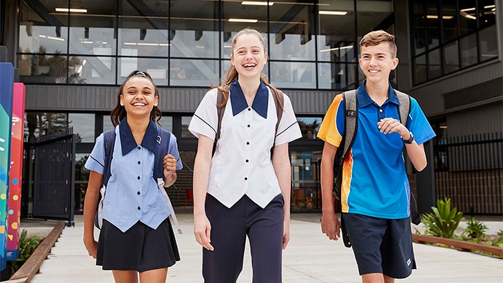 high school students walking out the front of school