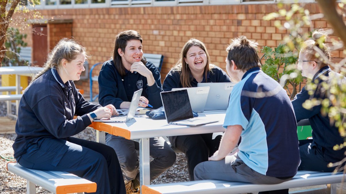 High school students sitting around a table at school