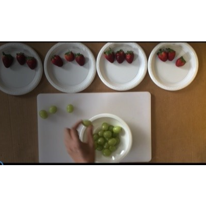 a bowl of green grapes and 4 bowls of strawberries