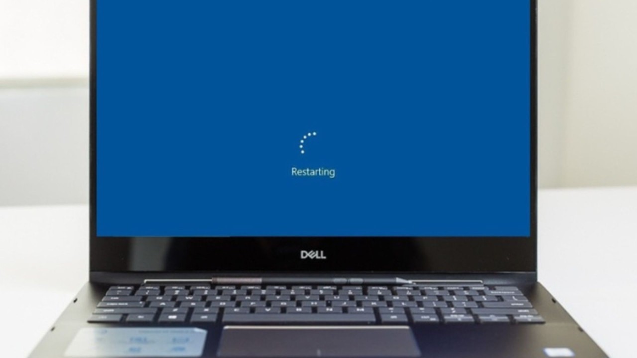 Laptop with the restarting graphic shown on the screen.