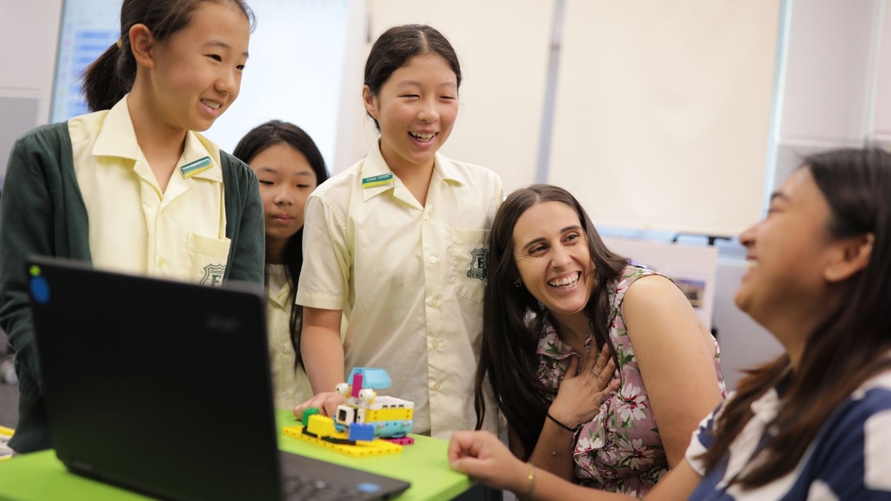 A group of students learning with their teachers on their laptop