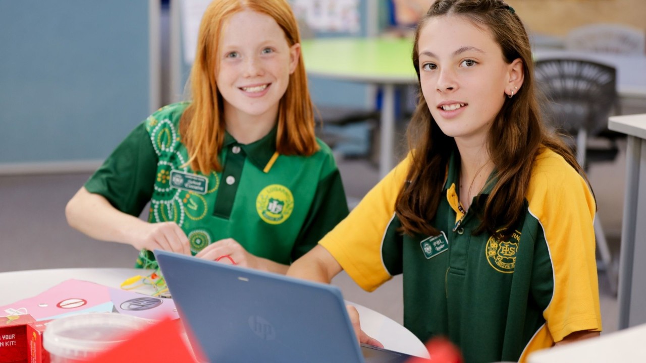 Two students smiling at camera