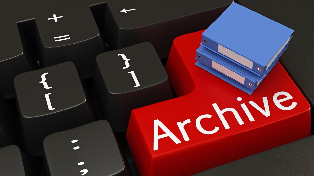 Keyboard with a red button with the word archive on it