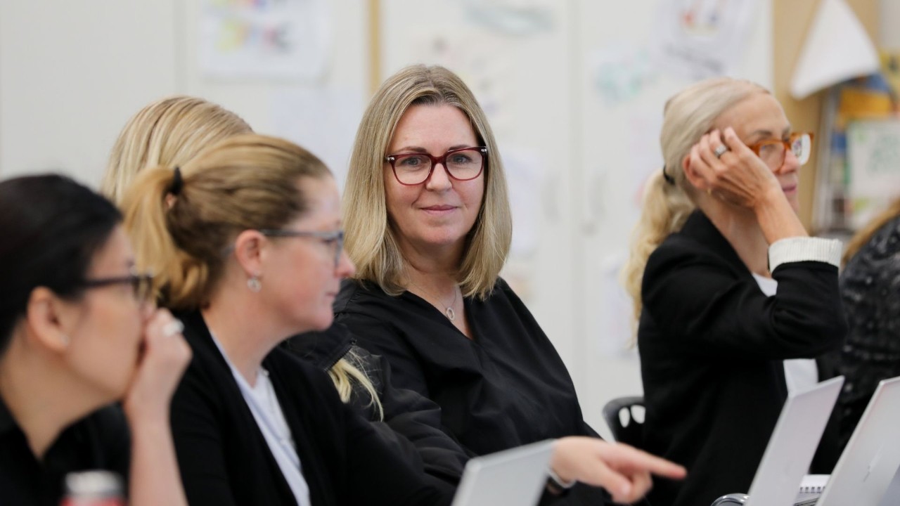 DOE staff member smiling at camera