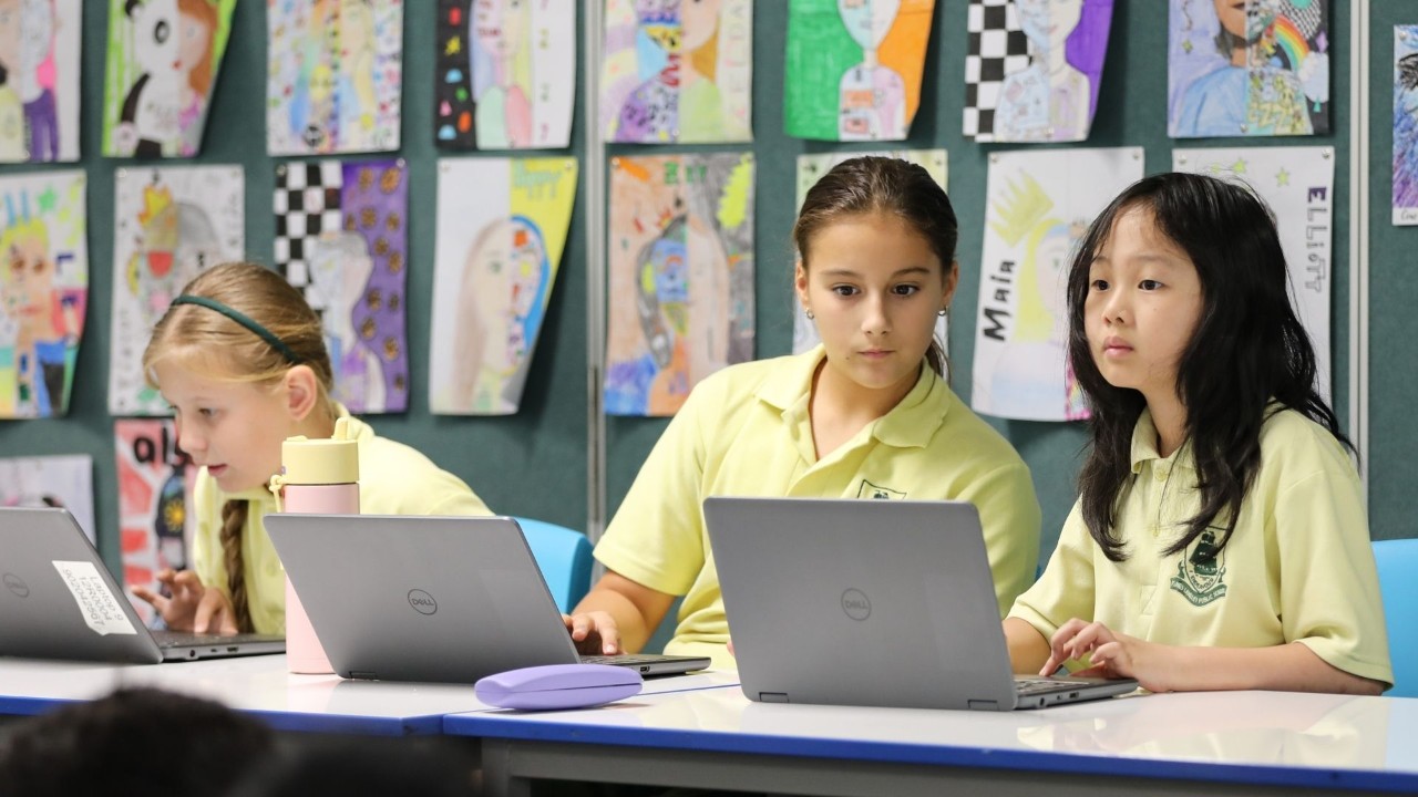 Students looking at laptop screens.