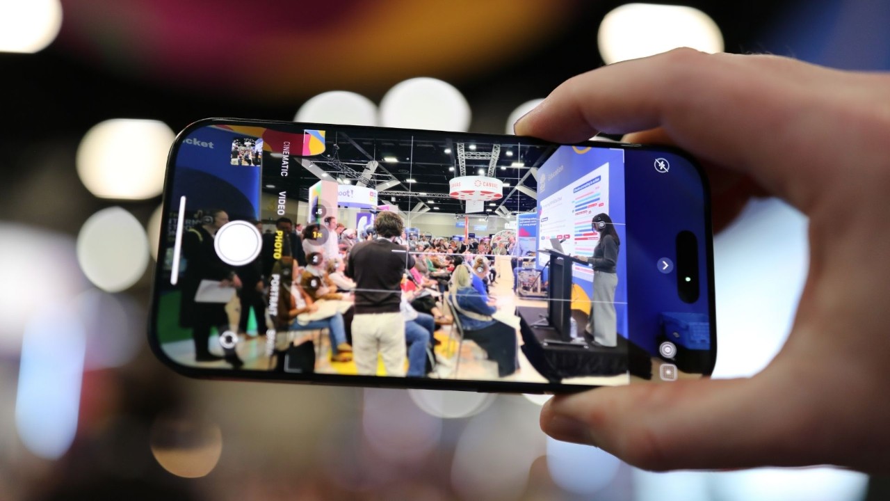 Image of a mobile device taking a picture of a large exhibition hall.