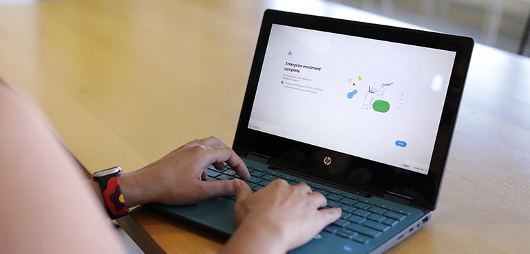 Over the shoulder shot of person using a Chromebook.