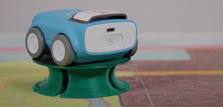 A blue Sphero indi car on top of a green stand.