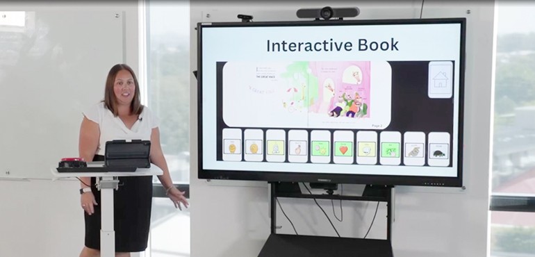 Kiri displaying an example of an interactive book for non-verbal students on a smart board.