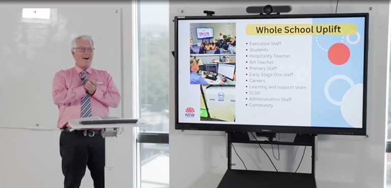 Michael giving a presentation using a smart board.