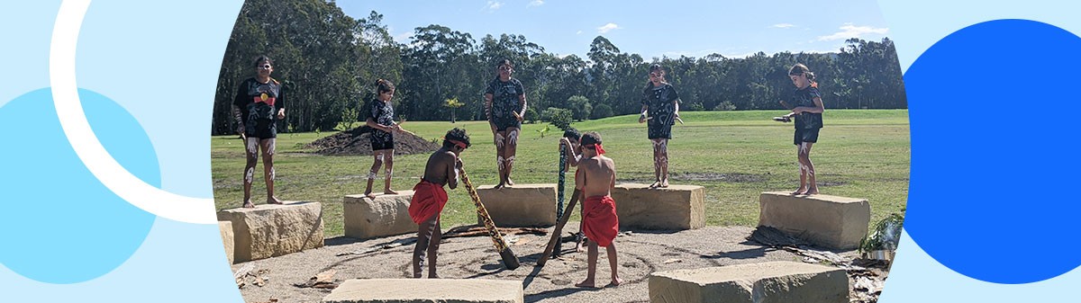 Aboriginal and Torres Strait Islander students playing music together in a yarning circle.