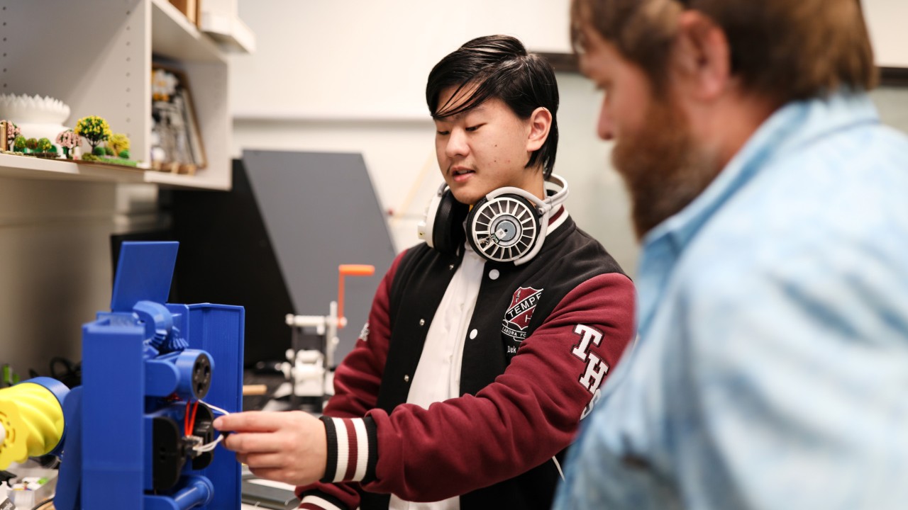 Ben and student using STEM equipment